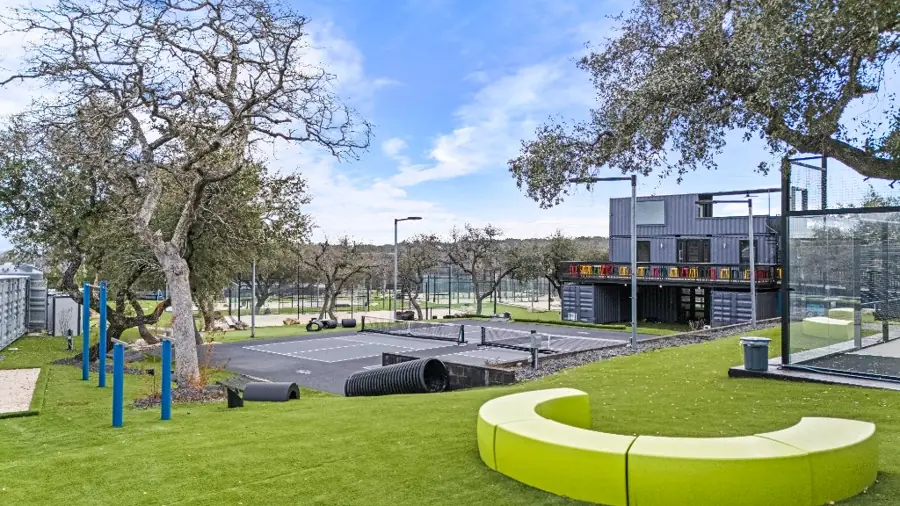 Outdoor calisthenics bars next to a lime-green bench