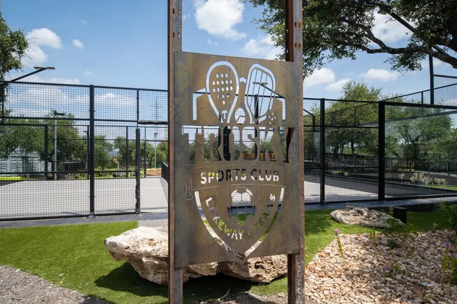 Laser-cut steel Trosky Sports Club sign in front of the padel courts